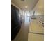 Well-lit kitchen featuring tile floors, and an adjacent laundry area with modern appliances at 344 Winter Ridge Blvd # 344, Winter Haven, FL 33881