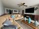 Comfortable living area featuring tile floors, a ceiling fan and a view into the dining area at 344 Winter Ridge Blvd # 344, Winter Haven, FL 33881