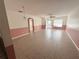 Bright and airy living room with tiled flooring, ceiling fan, and a view of the front door at 344 Winter Ridge Blvd # 344, Winter Haven, FL 33881