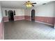 Open-concept living room with neutral tile flooring, and a half-painted accent wall at 344 Winter Ridge Blvd # 344, Winter Haven, FL 33881
