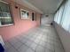 Spacious sunroom featuring tiled flooring, large windows, and access to the backyard at 344 Winter Ridge Blvd # 344, Winter Haven, FL 33881
