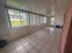 Enclosed sunroom with tiled floors, lots of natural light, and a door leading to the yard at 344 Winter Ridge Blvd # 344, Winter Haven, FL 33881