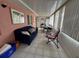 Enclosed sunroom with tile flooring, comfortable seating, and a dining area at 344 Winter Ridge Blvd # 344, Winter Haven, FL 33881