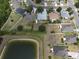 Wide aerial view showing the location of the house relative to community pond at 3638 Doe Run Dr, St Cloud, FL 34772