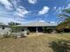 Backyard with lush greenery, a well-maintained lawn, and a cozy screened-in patio with a white picket fence at 3638 Doe Run Dr, St Cloud, FL 34772