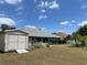 Spacious backyard featuring a shed, a fenced-in yard, and a well-maintained lawn on a sunny day at 3638 Doe Run Dr, St Cloud, FL 34772