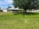 Lush backyard with a shed and a well-maintained lawn leading up to the main house at 3638 Doe Run Dr, St Cloud, FL 34772