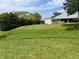 Spacious backyard with lush green lawn, a shed, and a clear view of the main house at 3638 Doe Run Dr, St Cloud, FL 34772