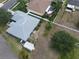 Aerial view showcasing a grassy yard with white fence and lush landscaping at 3638 Doe Run Dr, St Cloud, FL 34772