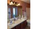 Dual sink bathroom featuring a large mirror and vanity at 3638 Doe Run Dr, St Cloud, FL 34772