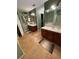 Bathroom boasting dual vanities, a soaking tub, and wood cabinets, creating a functional and comfortable space at 3638 Doe Run Dr, St Cloud, FL 34772