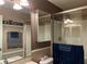 Shower stall featuring glass doors and neutral tones at 3638 Doe Run Dr, St Cloud, FL 34772