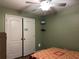 Comfortable bedroom with ceiling fan, large closet, and simple decor at 3638 Doe Run Dr, St Cloud, FL 34772
