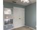 Bedroom featuring a closet, carpet flooring, and double doors, offering ample storage and privacy at 3638 Doe Run Dr, St Cloud, FL 34772