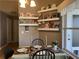 Charming dining area with a table set for a meal, display shelving and bright natural lighting at 3638 Doe Run Dr, St Cloud, FL 34772