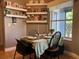 Charming dining area with a table set for a meal, display shelving and bright natural lighting at 3638 Doe Run Dr, St Cloud, FL 34772