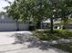 Nice single Gathering home with a three car garage featuring a light blue exterior with mature landscaping at 3638 Doe Run Dr, St Cloud, FL 34772