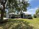 Charming home with a three car garage and nice curb appeal featuring a light blue facade and lush green lawn at 3638 Doe Run Dr, St Cloud, FL 34772