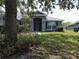 Charming single-story home featuring a light blue exterior, mature landscaping, and covered front entry at 3638 Doe Run Dr, St Cloud, FL 34772