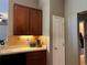Modern kitchen with wood cabinets, tile backsplash, and stainless steel appliances at 3638 Doe Run Dr, St Cloud, FL 34772