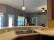 An open-concept kitchen featuring granite countertops, a sink, and a view into the living area at 3638 Doe Run Dr, St Cloud, FL 34772