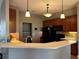 Bright kitchen with island seating, pendant lights, and modern appliances at 3638 Doe Run Dr, St Cloud, FL 34772
