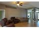 Cozy living room with tile floors, ceiling fan, and comfortable seating at 3638 Doe Run Dr, St Cloud, FL 34772