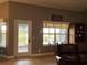 Cozy living room showcasing a bright window, comfortable seating, and stylish interior design at 3638 Doe Run Dr, St Cloud, FL 34772