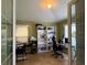A home office featuring neutral paint, tile floors, natural light and useful shelving at 3638 Doe Run Dr, St Cloud, FL 34772