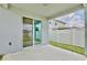 View of the back patio with sliding glass doors and a white fenced-in yard at 4327 Silver Creek St, Kissimmee, FL 34744