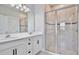 Bathroom featuring double vanity, shower with glass door, and modern finishes at 4327 Silver Creek St, Kissimmee, FL 34744