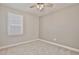 Cozy bedroom with plush carpeting, natural light, and a ceiling fan at 4327 Silver Creek St, Kissimmee, FL 34744