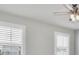 Bright bedroom featuring neutral walls, white trim, a ceiling fan and windows with white blinds at 4327 Silver Creek St, Kissimmee, FL 34744