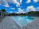 Community pool area with plenty of lounge chairs and palm trees to create a resort feel at 4327 Silver Creek St, Kissimmee, FL 34744