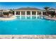 Large community pool and clubhouse with chairs and tables surrounding the pool at 4327 Silver Creek St, Kissimmee, FL 34744
