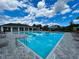 Community pool and clubhouse with chairs and tables and a shallow wading area at 4327 Silver Creek St, Kissimmee, FL 34744