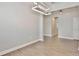 Spacious dining area features a modern lighting fixture, wood flooring, and access to adjacent rooms at 4327 Silver Creek St, Kissimmee, FL 34744