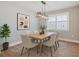 Well-lit dining room featuring a stylish light fixture and six chairs around a wooden table at 4327 Silver Creek St, Kissimmee, FL 34744