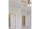 Hallway with two doors to walk in closets and a ceiling fan with lights at 4327 Silver Creek St, Kissimmee, FL 34744