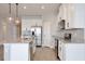 Modern kitchen featuring white cabinets, stainless steel appliances, granite countertops, and stylish lighting at 4327 Silver Creek St, Kissimmee, FL 34744