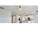 Open-concept living space features stylish pendant lighting, white cabinets, and stainless steel appliances at 4327 Silver Creek St, Kissimmee, FL 34744