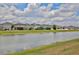 A wide view of the pond with several homes in the community as seen from the lawn at 4327 Silver Creek St, Kissimmee, FL 34744