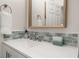 Bathroom features a modern vanity with green tile backsplash, sink, and mirror at 4722 Flagler Beach Way, Kissimmee, FL 34746