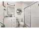 Well-lit bathroom featuring a glass shower, modern vanity, and hexagon wall decor at 4722 Flagler Beach Way, Kissimmee, FL 34746