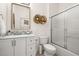 Bathroom with modern vanity, decorative mirror, commode and glass shower doors at 4722 Flagler Beach Way, Kissimmee, FL 34746