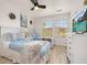 Bright bedroom with two twin beds, a dresser with TV and natural light at 4722 Flagler Beach Way, Kissimmee, FL 34746