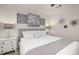 Bright bedroom features soft gray decor, artwork, a ceiling fan and stylish bedside lamps at 4722 Flagler Beach Way, Kissimmee, FL 34746
