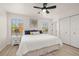 Bright bedroom featuring a ceiling fan, neutral walls, and wood-look flooring at 4722 Flagler Beach Way, Kissimmee, FL 34746