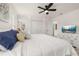 Light-filled bedroom with a ceiling fan, white dresser with TV, and closet at 4722 Flagler Beach Way, Kissimmee, FL 34746