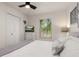 Bedroom with a bed dressed in white and grey tones, with a TV and natural light at 4722 Flagler Beach Way, Kissimmee, FL 34746